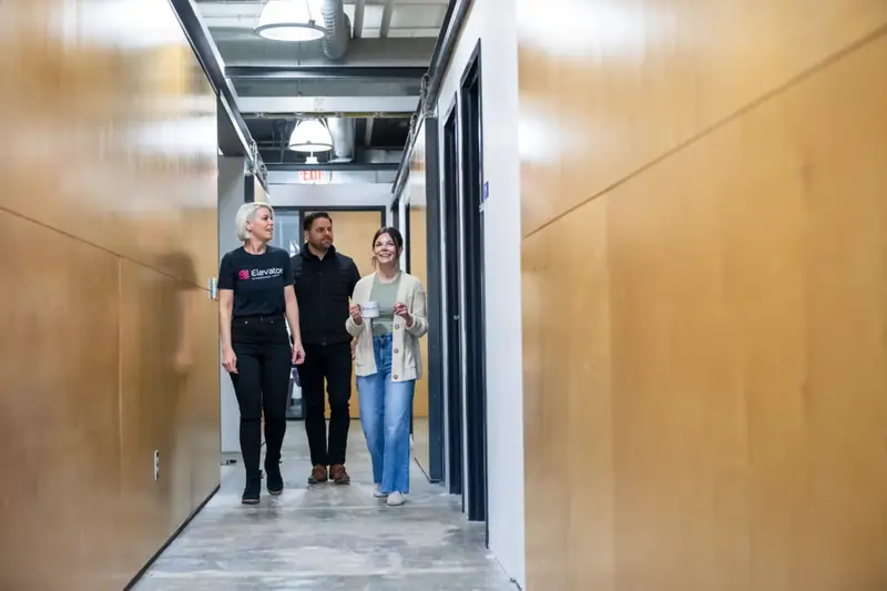 Members walking the warehouse unit hallway at Elevator Omaha