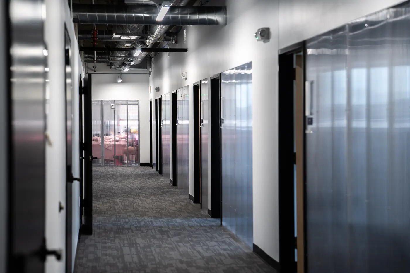 Private offices along the hallway at Elevator Des Moines