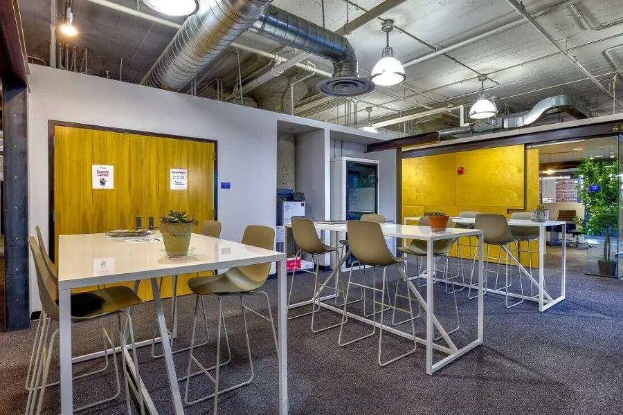 Open coworking tables at Elevator Omaha, drop-in seats by the office fronts