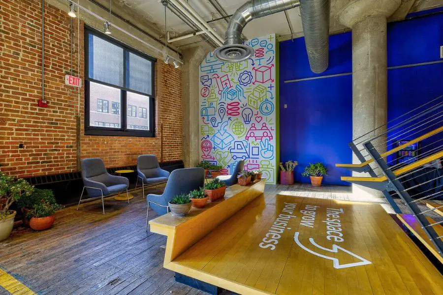 Lounge with mural and stadium seating at Elevator Omaha